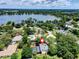Stunning aerial view showcasing the home, pool, and serene lake in a picturesque setting at 4030 Cool Water Ct, Winter Park, FL 32792