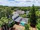 Aerial view of a home with a screened-in pool surrounded by lush greenery at 4030 Cool Water Ct, Winter Park, FL 32792