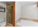 Bathroom featuring tile and a glass enclosed shower plus a soaking tub at 4030 Cool Water Ct, Winter Park, FL 32792