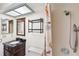 Bathroom featuring a vanity with drawers, mirror, skylight and shower at 4030 Cool Water Ct, Winter Park, FL 32792