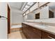 Stylish bathroom with double vanity, tiled floors, and a relaxing bathtub area at 4030 Cool Water Ct, Winter Park, FL 32792