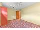 Bright bedroom with neutral walls, ceiling fan, closet space, and colorful patterned carpet at 4030 Cool Water Ct, Winter Park, FL 32792
