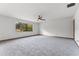 Bright bedroom with neutral carpet, ceiling fan, and window with a peaceful outdoor view at 4030 Cool Water Ct, Winter Park, FL 32792