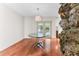 Dining room features a modern glass table and unique rock wall at 4030 Cool Water Ct, Winter Park, FL 32792