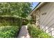 Home exterior featuring stone accents, lush greenery, and well-maintained landscaping at 4030 Cool Water Ct, Winter Park, FL 32792