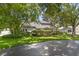 Charming home featuring lush landscaping and mature trees in a serene front yard setting at 4030 Cool Water Ct, Winter Park, FL 32792