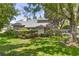 Well-maintained home featuring a manicured lawn and mature trees shading the front of the house at 4030 Cool Water Ct, Winter Park, FL 32792