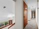 Bright hallway with carpeted floors, wooden doors, and a view of the front entrance at 4030 Cool Water Ct, Winter Park, FL 32792