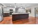Modern kitchen with large island, stainless appliances, and backyard view at 4030 Cool Water Ct, Winter Park, FL 32792