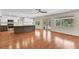 Open floor plan reveals a renovated kitchen with white cabinets and stainless steel appliances at 4030 Cool Water Ct, Winter Park, FL 32792