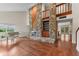 Spacious living room featuring a stone fireplace, hardwood floors, and plenty of natural light at 4030 Cool Water Ct, Winter Park, FL 32792