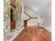 Open-concept living room with stone fireplace, hardwood floors, and staircase at 4030 Cool Water Ct, Winter Park, FL 32792