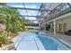 Backyard screened in pool area with landscaped waterfall feature at 4030 Cool Water Ct, Winter Park, FL 32792