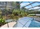 Backyard screened in pool area with landscaped waterfall and spa at 4030 Cool Water Ct, Winter Park, FL 32792