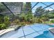 Backyard screened in pool area with landscaped waterfall at 4030 Cool Water Ct, Winter Park, FL 32792