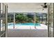 View of backyard screened in pool area with well maintained landscaping at 4030 Cool Water Ct, Winter Park, FL 32792