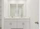 Bright bathroom featuring a white double sink vanity with chrome fixtures and tiled floors at 4325 Switchgrass Ln, St Cloud, FL 34772