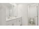 Modern bathroom with double sink vanity featuring white cabinets, quartz countertop and tiled floors at 4325 Switchgrass Ln, St Cloud, FL 34772