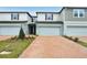 Charming townhome featuring a two-car garage and a well-manicured front yard at 4325 Switchgrass Ln, St Cloud, FL 34772
