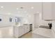 Modern kitchen with white cabinets, stainless steel appliances, and an island with a sink at 4325 Switchgrass Ln, St Cloud, FL 34772