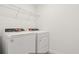 Functional laundry room with white washer and dryer and wire shelving for storage at 4325 Switchgrass Ln, St Cloud, FL 34772