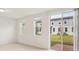 Sunlit living area with sliding glass doors leading to a backyard patio space at 4325 Switchgrass Ln, St Cloud, FL 34772