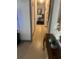 Bright hallway with neutral walls, decorative mirror, and hardwood flooring at 4820 Kathy Jo Ter, Orlando, FL 32808