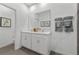 Modern bathroom with a double vanity, large mirror, and elegant gray tile flooring at 490 Belmond Dr, Debary, FL 32713