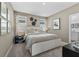 Serene bedroom with a well-made bed, stylish decor, and two windows for natural light at 490 Belmond Dr, Debary, FL 32713