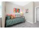 Cozy bedroom featuring a comfortable twin bed, soft gray carpet, and a colorful 'Play' wall art at 490 Belmond Dr, Debary, FL 32713