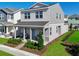 Stylish two-story home showcasing a welcoming front porch, landscaped garden, and charming architectural details at 490 Belmond Dr, Debary, FL 32713