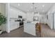 Modern kitchen with white cabinets, stainless steel appliances, a large island with seating, and stylish pendant lighting at 490 Belmond Dr, Debary, FL 32713