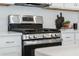 Close-up of a modern stainless steel gas range, highlighting the sleek design and professional-grade features at 490 Belmond Dr, Debary, FL 32713