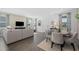 Inviting living area with a gray sectional, stylish décor, and a round dining table at 490 Belmond Dr, Debary, FL 32713