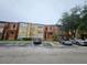 Multi-Gathering home with a parking lot and some lawn area with mature trees, creating a pleasant atmosphere at 5160 Conroy Rd # 1437, Orlando, FL 32811