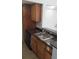 This kitchen features wood cabinets, a black dishwasher, and a stainless steel sink at 5160 Conroy Rd # 1437, Orlando, FL 32811