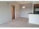 Open-concept living space with neutral tones, a pendant light fixture, and an adjacent closet entrance at 5160 Conroy Rd # 1437, Orlando, FL 32811