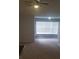 Inviting living room with large windows, neutral carpet, and ceiling fan providing ample natural light and comfort at 5160 Conroy Rd # 1437, Orlando, FL 32811