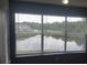 Scenic view of a serene lake through large windows, offering a tranquil and picturesque outlook at 5160 Conroy Rd # 1437, Orlando, FL 32811