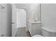 Well-lit half bathroom featuring elegant fixtures, tiled floors, and a clean, modern design at 558 Orient Ave, Debary, FL 32713