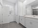Bathroom with dual sinks, white cabinets, and tile flooring at 558 Orient Ave, Debary, FL 32713