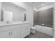 Modern bathroom features double sinks, a large mirror, tile flooring, and a shower-tub combo at 558 Orient Ave, Debary, FL 32713