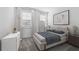 Airy bedroom with two windows featuring white curtains and blinds, neutral decor, and carpet at 558 Orient Ave, Debary, FL 32713