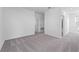 Bright bedroom featuring neutral walls, plush carpet, and doorway leading to bathroom and closet at 558 Orient Ave, Debary, FL 32713