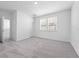 Bright bedroom with gray carpet, natural light, and white trim at 558 Orient Ave, Debary, FL 32713