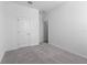 Comfortable bedroom with neutral walls, plush carpeting, and a closet for storing personal items at 558 Orient Ave, Debary, FL 32713