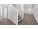 Lovely entryway features neutral walls, wood-look floors and a staircase with carpeted treads at 558 Orient Ave, Debary, FL 32713