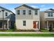 Charming two-story home featuring neutral tones, a red front door, and manicured landscaping at 558 Orient Ave, Debary, FL 32713