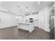 Modern kitchen features stainless appliances, white cabinets, a center island, and hard surface floors at 558 Orient Ave, Debary, FL 32713