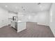 Spacious kitchen boasts stainless appliances, white cabinets, a center island, and hard surface floors at 558 Orient Ave, Debary, FL 32713